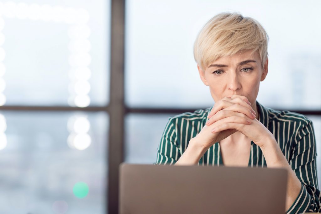 Anxious Business Woman Thinking On Probems Sitting In Modern Office